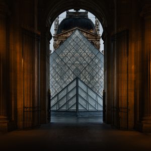 Interior of the Louvre with a grand arched doorway and tall Gothic style windows